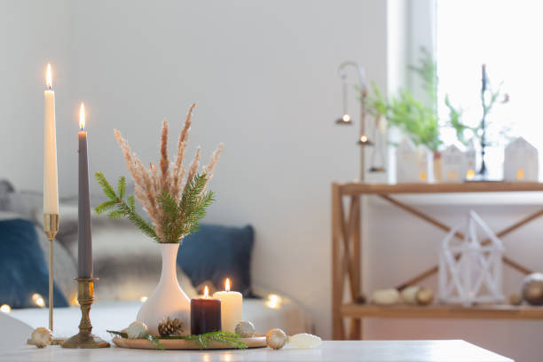 istock burning candles with christmas decor in white cozy interior 1439326859