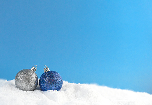 Christmas ornaments in the snow with empty space