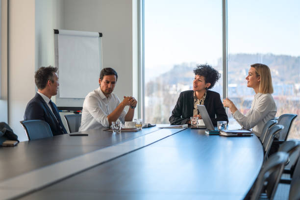 istock A Small Group of Business Colleagues Discussing Plans Around A Conference Table 1439328871