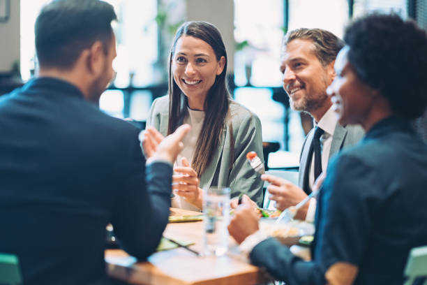 Group of business persons having lunch together