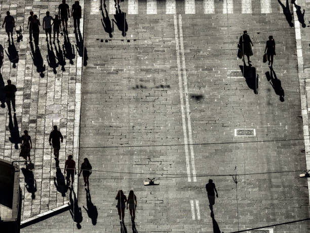 istock Silhouettes of pedestrians casting long shadows 1439334145