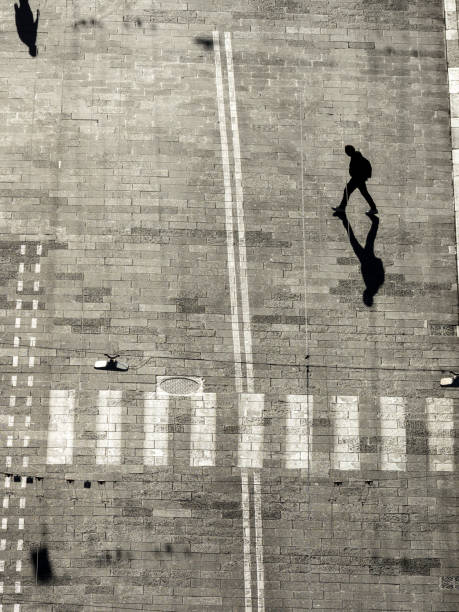 istock Silhouettes of two pedestrians casting long shadows 1439334161