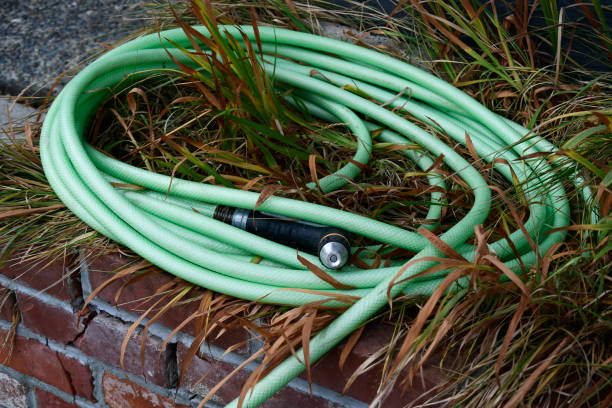 istock Old Green Garden Hose and Nozzle 1439334235
