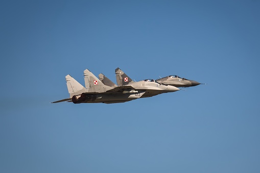 F/A-18 Super Hornet in flight against a blue sky background.