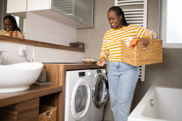 istock Young woman doing her laundry at home 1439340535