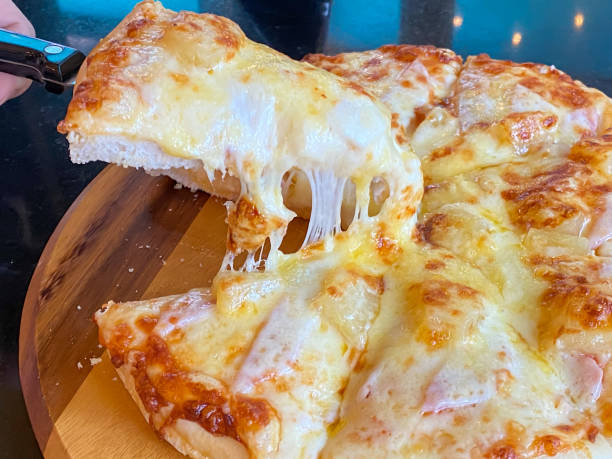 istock Slice of hot pizza Hawaiian 1439343900