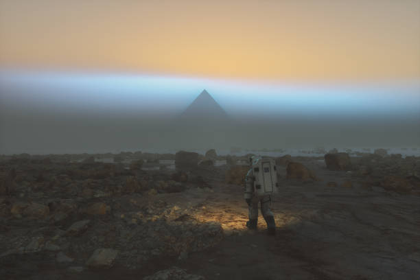 istock Astronaut walking towards mysterious pyramid on distant planet 1439343922