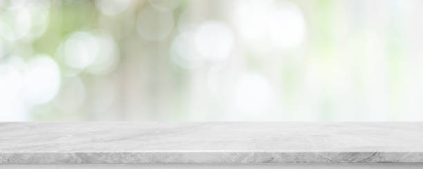 istock Empty white marble stone table top and blur glass window interior cafe and restaurant banner mock up abstract background - can used for display or montage your products. 1439348132