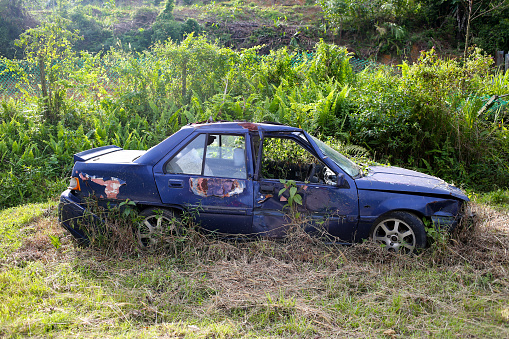 Vehicle in bad state abandoned at the roadside.