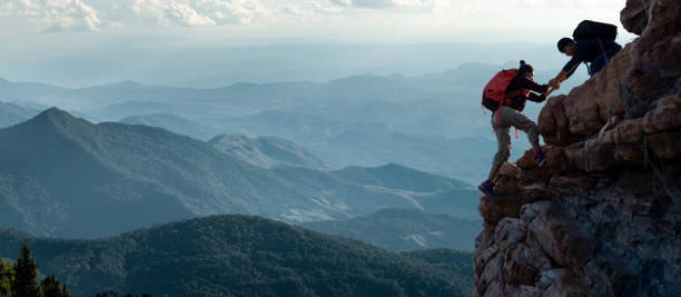 istock Group of happy hiker jumping on the hill 1439365896