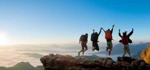 istock Group of happy hiker jumping on the hill 1439365897