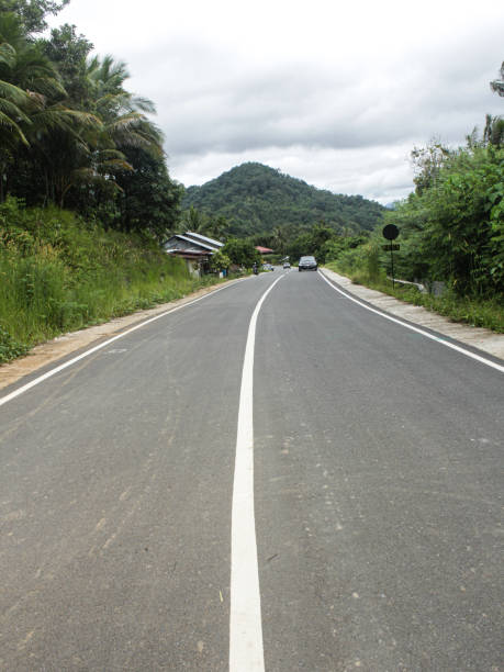 istock slightly curved asphalt road in hilly area 1439369383