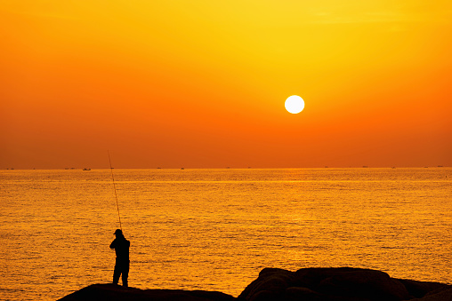 fishing people on the rock at sunrise. Sokcho-si, Gangwon-do.