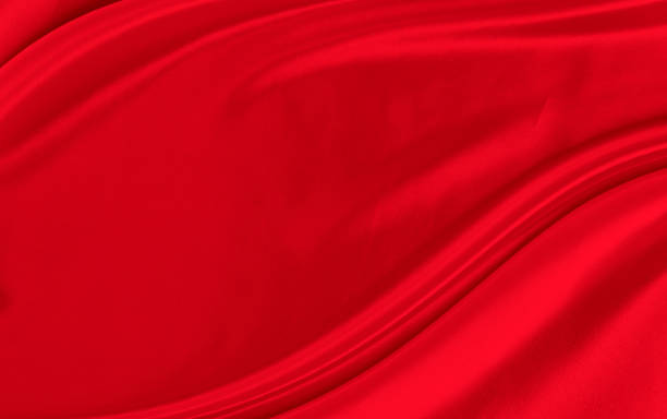 istock Black red satin dark fabric texture luxurious shiny that is abstract silk cloth background with patterns soft waves blur beautiful. 1439387314