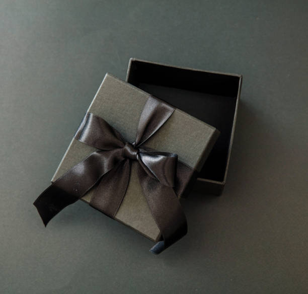 istock Black Friday sale concept, Gift box open with ribbon, black background, overhead. 1439388799