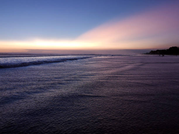 beautiful sunset at Seminyak beach, a famous tourist area on the west coast of Bali, Indonesia