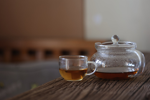 Cup of tea with mint and lemon on a white background