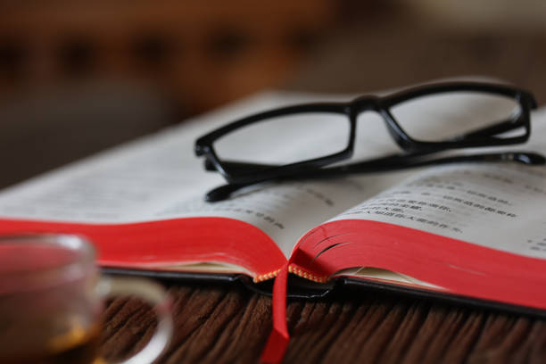 Blue Eyeglasses On Book At Table
