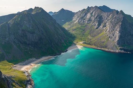 A mesmerizing scene of Kvalvika beach located in Norway on a sunny day