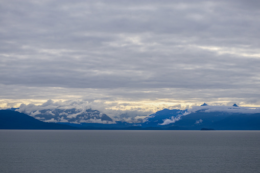 A shot of some cloud covered mountain peaks taken on the way to Juneau, Alaska.