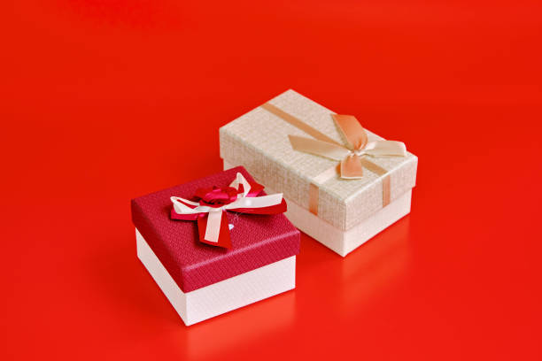 small and medium gift boxes on red background. Objects with red background.