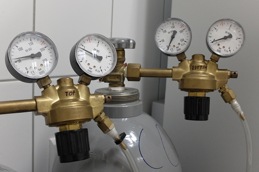 Two pressure regulators attached to CO2 gas cylinders. Such equipment is used to maintain appropriate atmosphere for cell and tissue culture