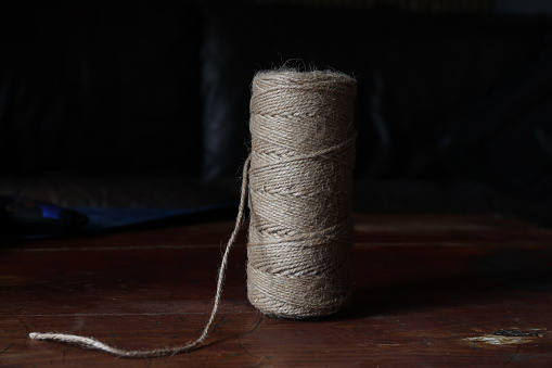 Roll of a twine jute on a wood.
