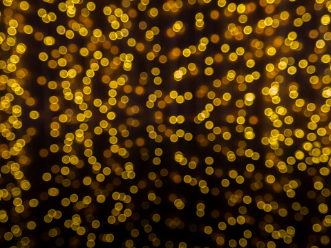 Led lights blur background. dark gold and black. defocused.