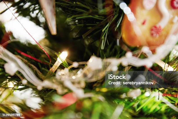 Blurred Bright Christmas Garland And Lamp On The Spruce Branch In Interio Stock Photo - Download Image Now