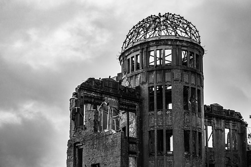 The view of Atomic Bomb Dome or Genbaku Dome at Hiroshima Peace Memorial Park in Hiroshima Japan against a cloudy sky