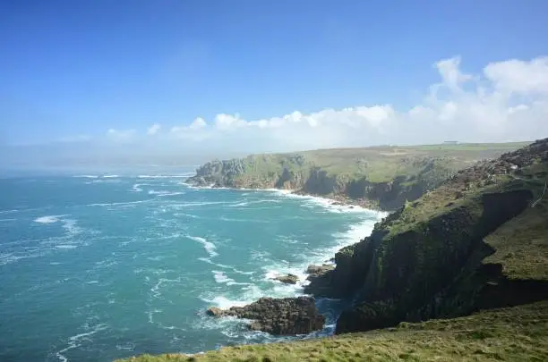 Photo of Land's End under the sunlight and a blue sky at daytime in western Cornwall in England