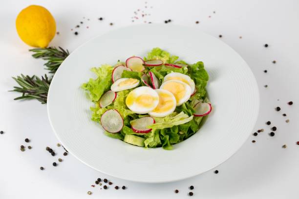 istock Tasty salad with lettuce radish and eggs on a white background 1439413793