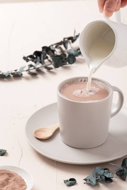 Closeup high angle shot of a latte cup and some decorations on a white table background
