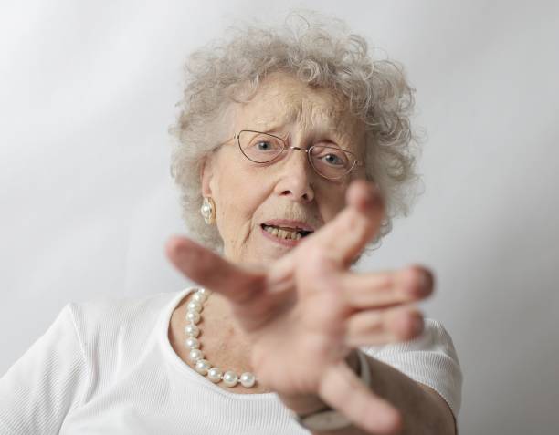 istock Old female with grey hair refusing to take a picture 1439417557