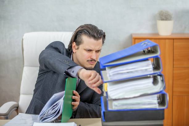 istock Young businessman working from his office  - the concept of hard work 1439417767