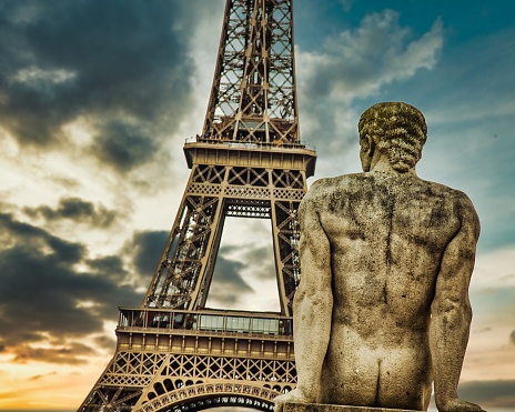 A low angle shot of a male statue at Place of Trocadero near Eiffel Tower, Paris, France