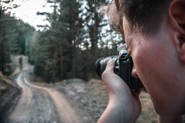 istock Man taking photos with a professional camera 1439419102