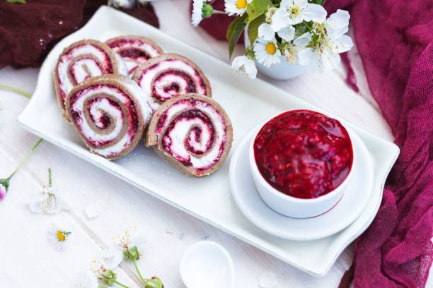 istock Amazing view of tasty looking raspberry rolls and raspberry jam put on a white plate 1439419916