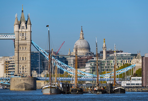 Moored Boats Line the River Thames with Iconic Landmarks