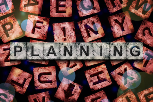 istock Planning, word on an alphabet on stone blocks, on a red background, with different letters. 1439420805