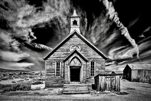 A grayscale shot of an old abandoned church at Bodie State Historic Park in California