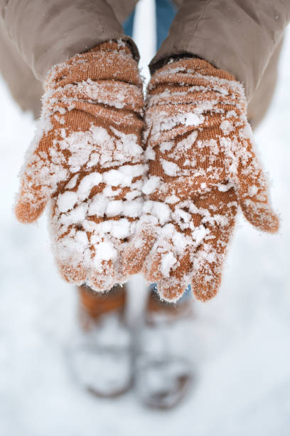 istock gloved hands in the snow in winter close 1439421826