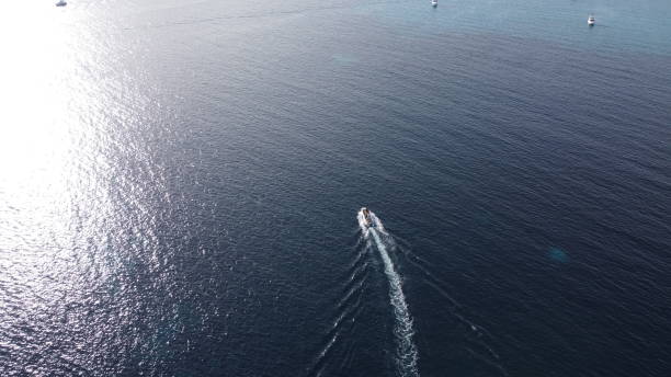 istock Little boat in the blue sea 1439424137