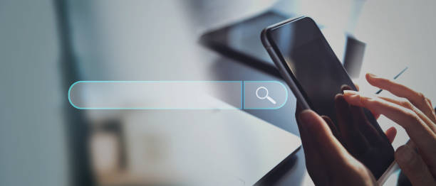 istock Data Search Technology. Search Engine Optimization SEO. Woman searching online information with search bar on virtusl screen 1439424600