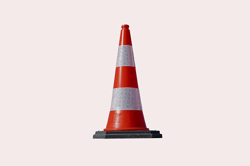 Traffic cone of orange and white color isolated on white background.