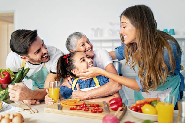 istock Happy family cooking together in a kitchen 1439427399