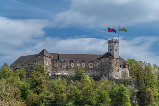 Springtime in slovenia Ljubljana University Square with Ljubljana Castle perched upon a hill in the background on a sunny spring day. ljubljana castle stock pictures, royalty-free photos & images