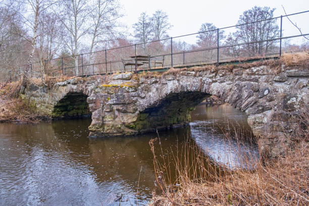 istock Arch bridge by a watercourse in the spring 1439431427