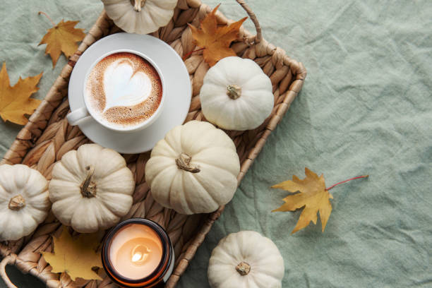 istock White pumpkins, coffee and autumn leaves on a wicker tray. 1439431676