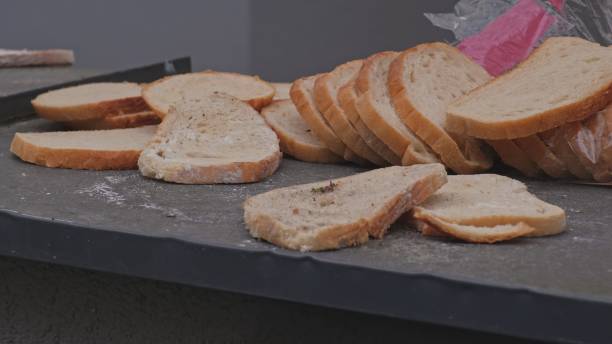 istock Loaf of Sliced Stale Bread Thrown Away By Dumpster Bins 1439432015